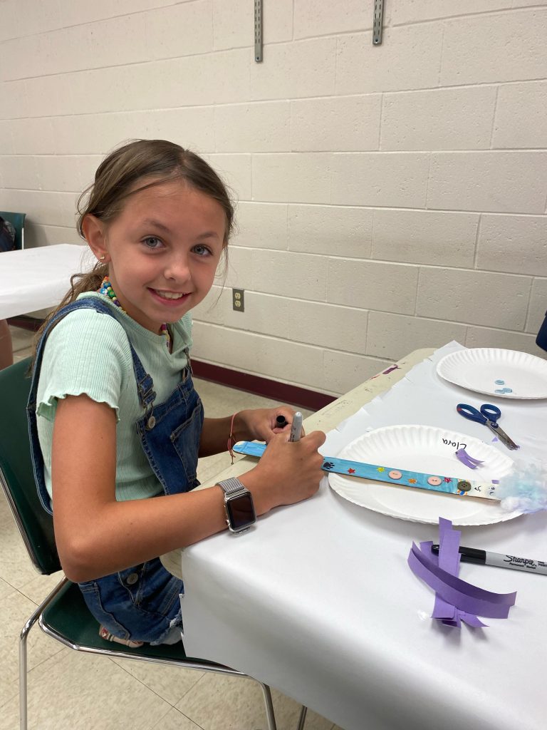 a young girl doing arts and crafts