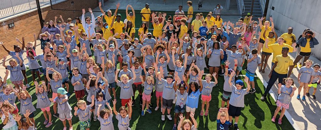 a group of young campers posing in the sun