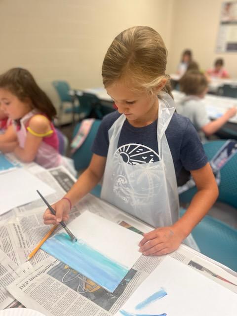 a young girl doing an art project