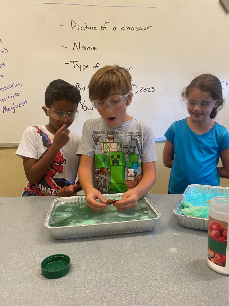 a group of young kids doing an arts project
