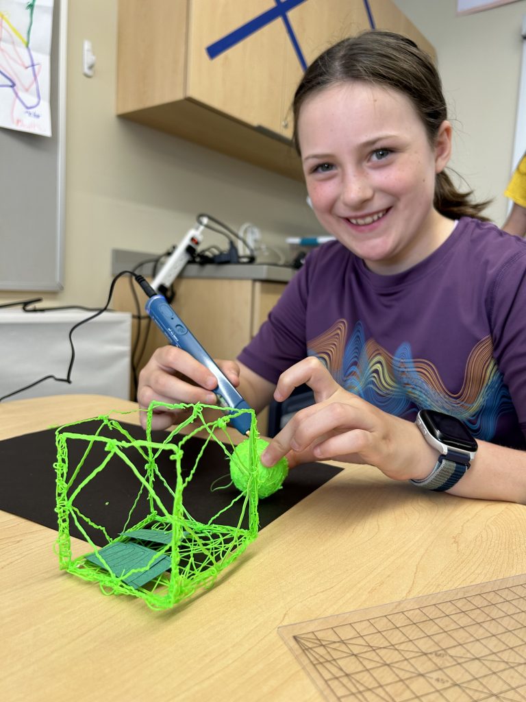 a young girl posing with her 3D printed project