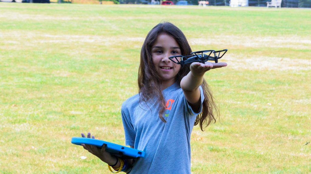 A girl with a drone during a STEAM camp program